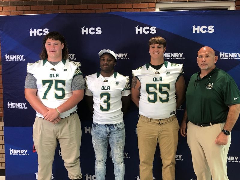 Ola football coach Tom Causey with three of his top players for the 2022 team: Neil Sledge, Joel Jones and Peyton Morefield. 