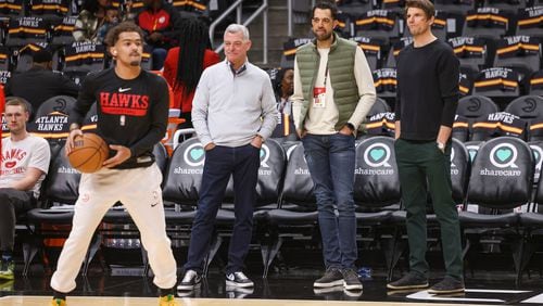 Atlanta Hawks guard Trae Young prepares to shoot while (from left) Hawks owner Tony Ressler, general manager Landry Fields and assistant GM Kyle Korver watch before the Hawks' game against the Cleveland Cavaliers at State Farm Arena, Friday, Feb. 24, 2023, in Atlanta. (Jason Getz/The Atlanta Journal-Constitution/TNS)