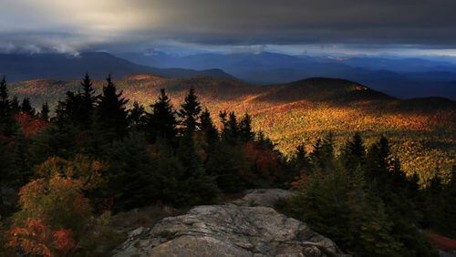 FILE - In this Oct. 4, 2016 file photo, fall foliage colors a line of mountains in Chatham, N. H. New England's 2017 fall foliage forecast is very favorable for leaf peeping. (AP Photo/Robert F. Bukaty, File)