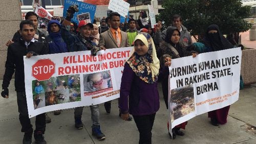 Protesters marched around the CNN Center in downtown Atlanta Saturday, calling for an end to the deadly violence targeting the Rohingya, a stateless Muslim minority that is being driven out of its predominantly Buddhist homeland of Myanmar. JEREMY REDMON/jredmon@ajc.com