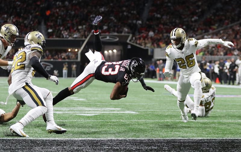 Falcons wide receiver Russell Gage makes a catch just short of the end zone between New Orleans Saints defenders Thursday, Nov. 28, 2019, at Mercedes-Benz Stadium in Atlanta. 
