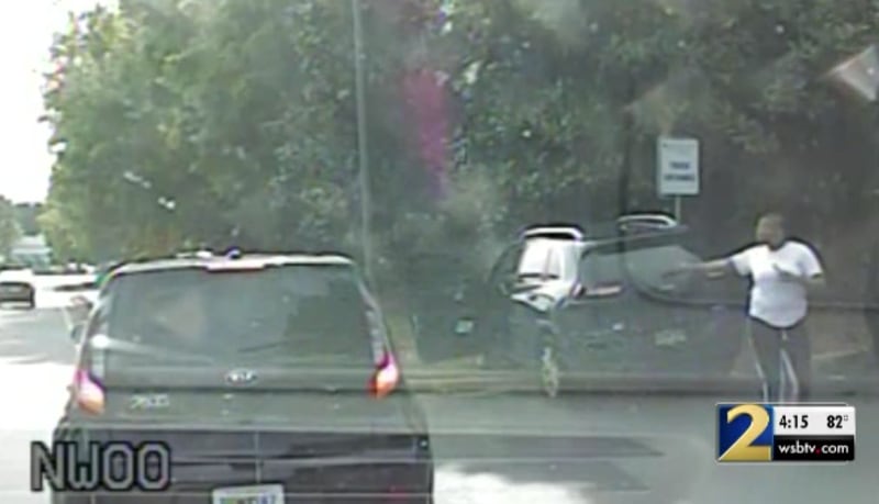 This is a screenshot of police dashcam video that shows the wrecked vehicles at the intersection of Peachtree Industrial Boulevard and Pleasant Hill Road.