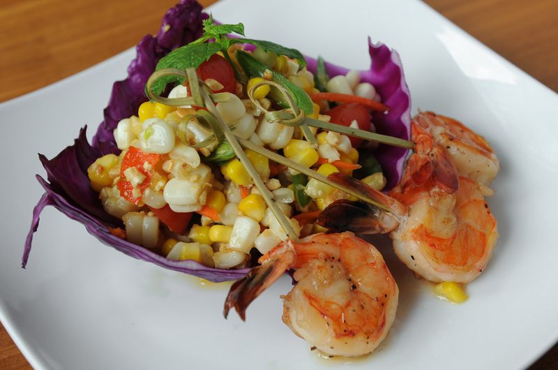 Corn Salad with white and yellow corn, cherry tomatoes, peanuts and green chili tossed in traditional Thai dressing and served with grilled shrimp. (BECKY STEIN PHOTOGRAPHY)