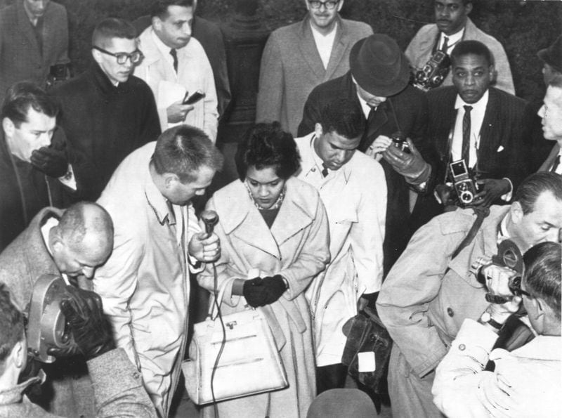 Charlayne Hunter and Hamilton Holmes, the first black students at the University of Georgia, arrive on the campus in January 1961 while surrounded by reporters. (Charles Pugh / AJC file)