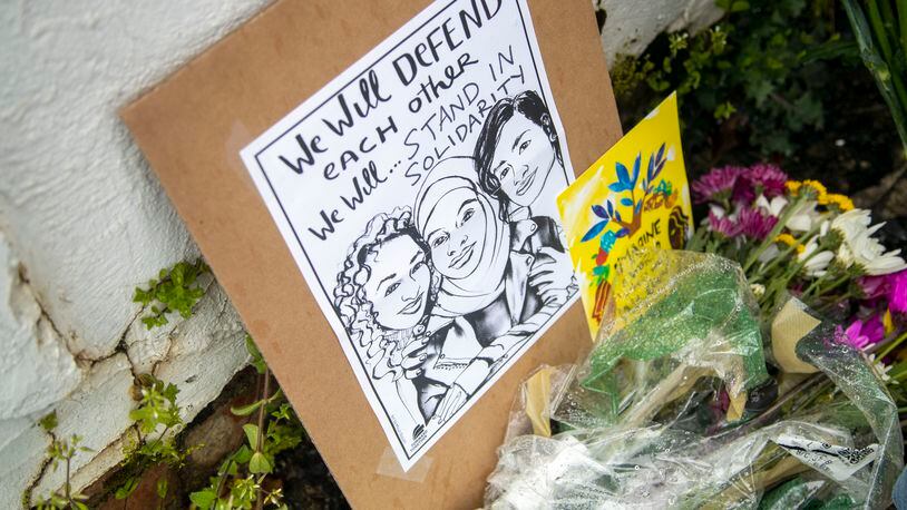 Flowers, candles and signs are displayed at a makeshift memorial outside of the Gold Spa in Atlanta on Wednesday.