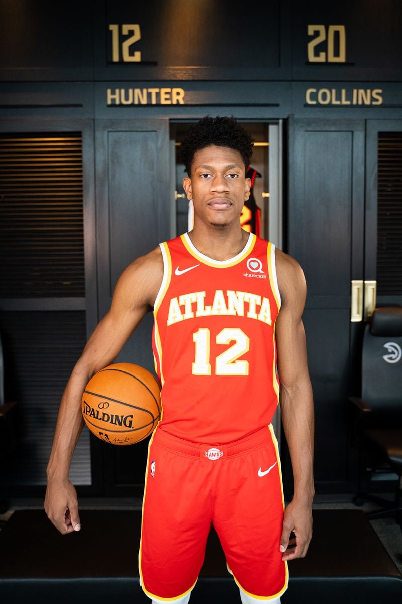 Hawks' De'Andre Hunter models the new "torch red" uniforms for next season.