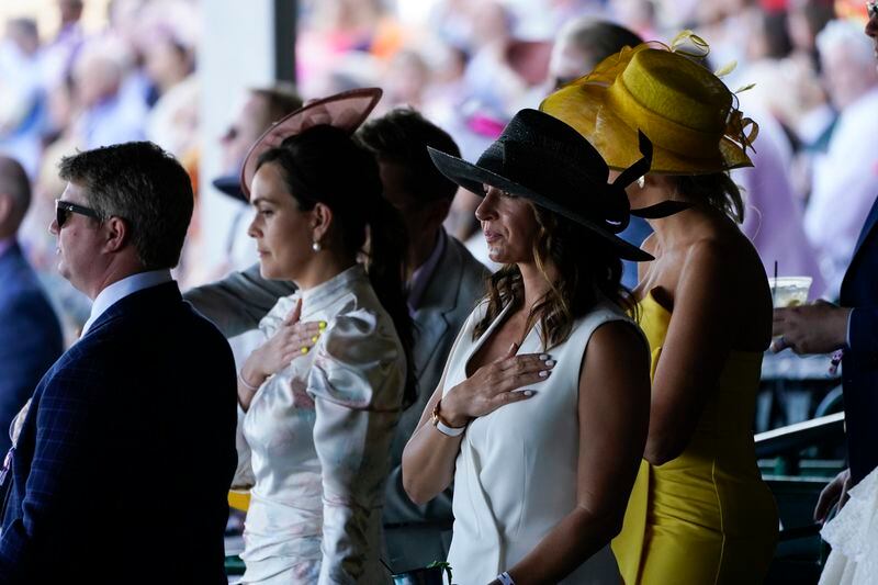 Fans stand for the national anthem before the 147th running of the Kentucky Derby at Churchill Downs, Saturday, May 1, 2021, in Louisville, Ky. (AP Photo/Charlie Riedel)