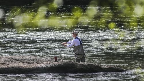 An Atlanta man fly fishes on the Chattahoochee River in Cobb County. The state last year increased the fees for fishing and hunting licenses. The additional money is being used to maintain public hunting and fishing areas and hire more game wardens. JOHN SPINK/JSPINK@AJC.COM