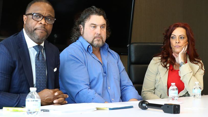Attorney Shean Williams (from left), Noel Hall and his wife Christie speak to reporters in March 2020. Hall was shot by an Atlanta police officer in 2017 as he drove his car away from the officer during a traffic dispute. The city council voted Monday to settle the North Carolina man's lawsuit for $990,000.