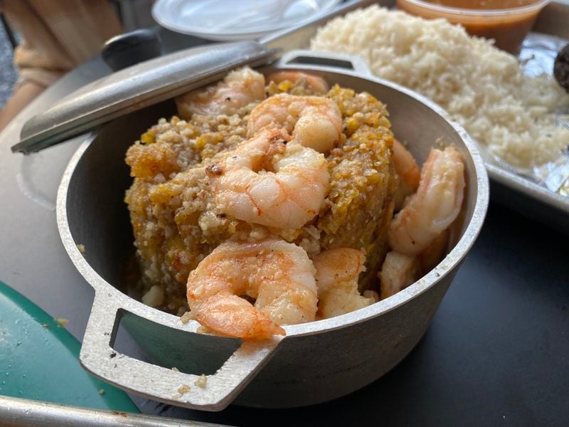At Raul's Latin Kitchen, mofongo, a filling dish of garlic-laced fried plantains, comes with your choice of protein. Here, it is studded with shrimp. (Ligaya Figueras / ligaya.figueras@ajc.com)