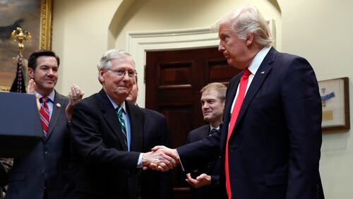 FILE - In this Feb. 16, 2017, file photo, President Donald Trump shakes hands with Senate Majority Leader Mitch McConnell of Ky., during a ceremony in the Roosevelt Room of the White House in Washington. Trumps attacks on McConnell come at the worst possible time, if the presidents goal is actually to accomplish the agenda on health care, infrastructure and taxes hes goading his GOP ally to pass. Behind from left are Rep. Evan Jenkins, R-W.Va., and Rep. Jim Jordan, R-Ohio.(AP Photo/Carolyn Kaster, File)