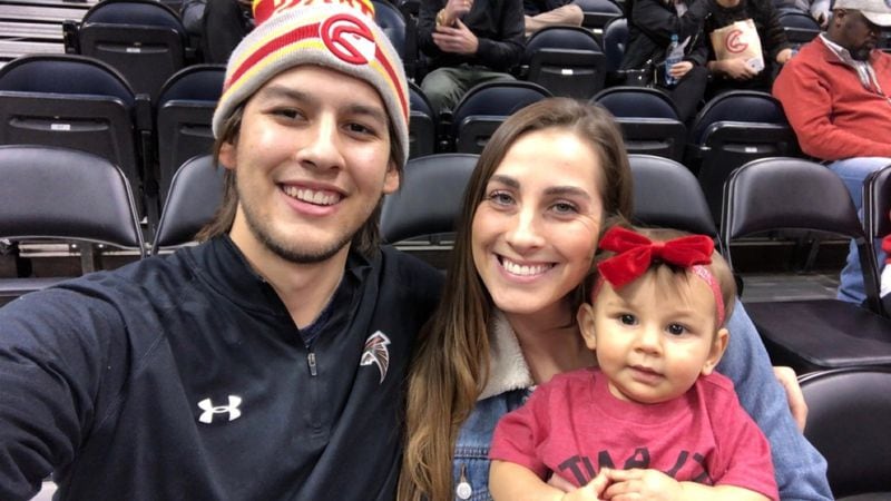 Ben McCleskey, Avery Armstrong and their daughter JoJo at a recent Atlanta Hawks game. CONTRIBUTED