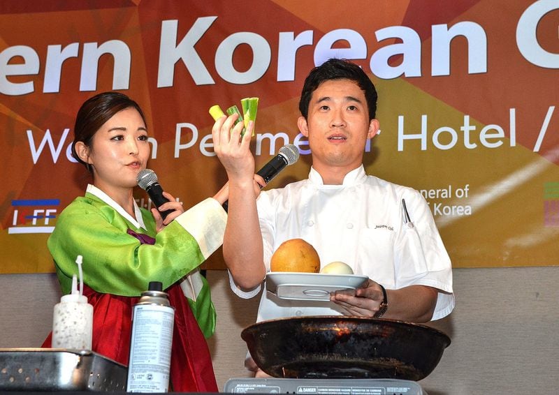 Master of ceremonies Angela Kim (left) and chef Jason Oh show the ingredients they’ll use as they prepare to demonstrate how to cook the main dish of braised short ribs (galbijjim) for the attendees of the Chuseok event. The Consulate General of the Republic of Korea in Atlanta invited more than 100 influential guests from Georgia — including lawmakers, business executives and food bloggers — to the dinner to experience Korean food and culture and celebrate the Chuseok holiday. The gala was held Oct. 5, 2017, at the Westin Atlanta Perimeter North. (Chris Hunt/Special for The AJC)