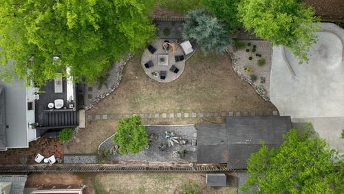 An aerial photo shows a concrete skate bowl (upper right) in the Atlanta backyard of Alison Michaels-Fandel and her husband, Derek Fandel, who enjoys skateboarding, Thursday, April 13, 2023. The Grant Park yard's transformation also includes a concrete fireplace with an adjacent sitting area (upper center). (Hyosub Shin / Hyosub.Shin@ajc.com)