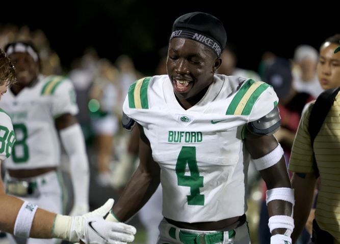 August 20, 2021 - Kennesaw, Ga: Buford wide receiver Tobi Olawale (4) celebrates his second receiving touchdown with teammates during the second half against North Cobb at North Cobb high school Friday, August 20, 2021 in Kennesaw, Ga.. Buford won 35-27. JASON GETZ FOR THE ATLANTA JOURNAL-CONSTITUTION