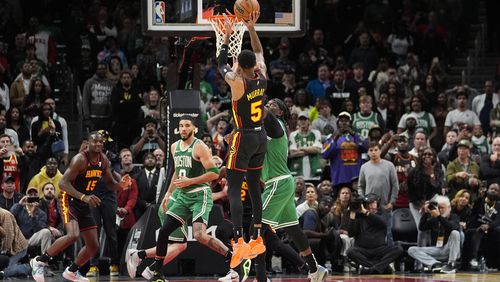 Atlanta Hawks guard Dejounte Murray (5) hits a game-winning basket during overtime in an NBA basketball game against the Boston Celtics Thursday, March 28, 2024, in Atlanta. The Hawks won 123-122 in overtime. (AP Photo/John Bazemore)