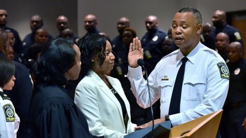 Ronald Applin is sworn in as Atlanta Public Schools police chief before Chief Magistrate Judge Cassandra Kirk in 2016. He authorized an investigation into police officer test-cheating allegations. HYOSUB SHIN / HSHIN@AJC.COM