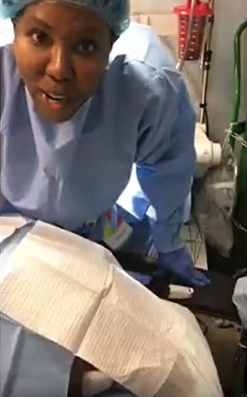 Dr. Windell Boutte speaks to the camera while a patient lies on the operating table in this video. The video is one of 20 that Boutte shared on YouTube that shows her dancing and singing over exposed patients. (YouTube)