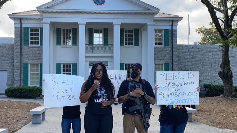 Zoe Bambara stands in front of Confederate Hall  at Stone Mountain Park with a modest few people and broadcasts her speech via Instagram live on Thursday, June 4, 2020. (Photo: Special to the AJC)
