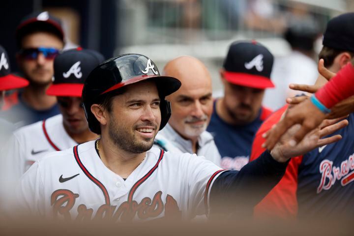 Braves catcher Travis d'Arnaud gets high-fives in the ninth inning. The Braves rallied, but the Astros won 5-4 Sunday at Truist Park. (Miguel Martinez / miguel.martinezjimenez@ajc.com)