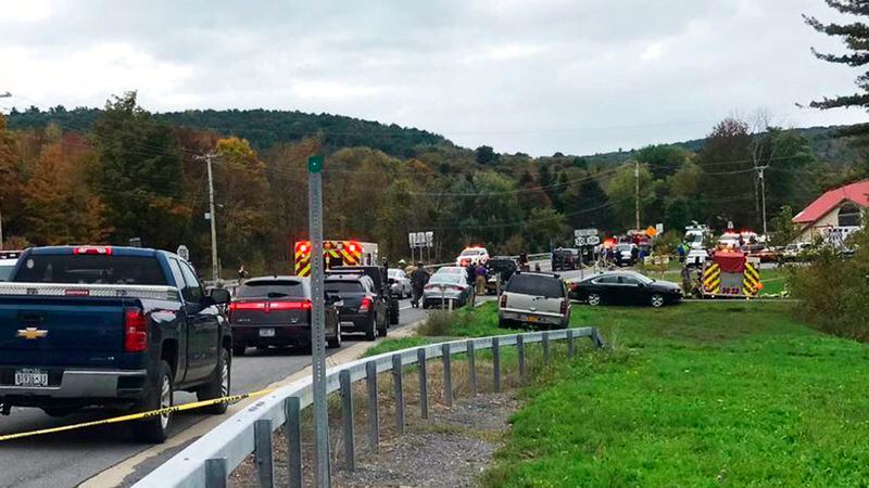 In this Saturday, Oct. 6, 2018 photo, emergency personnel respond to the scene of a deadly crash in Schoharie, N.Y. (WTEN via AP)
