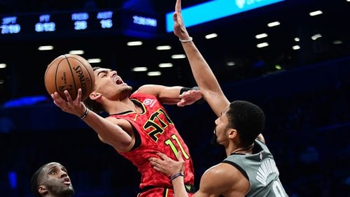 Hawks guard Trae Young is fouled by the Nets' Spencer Dinwiddie during the second half Saturday, Dec. 21, 2019, at Barclays Center in New York.