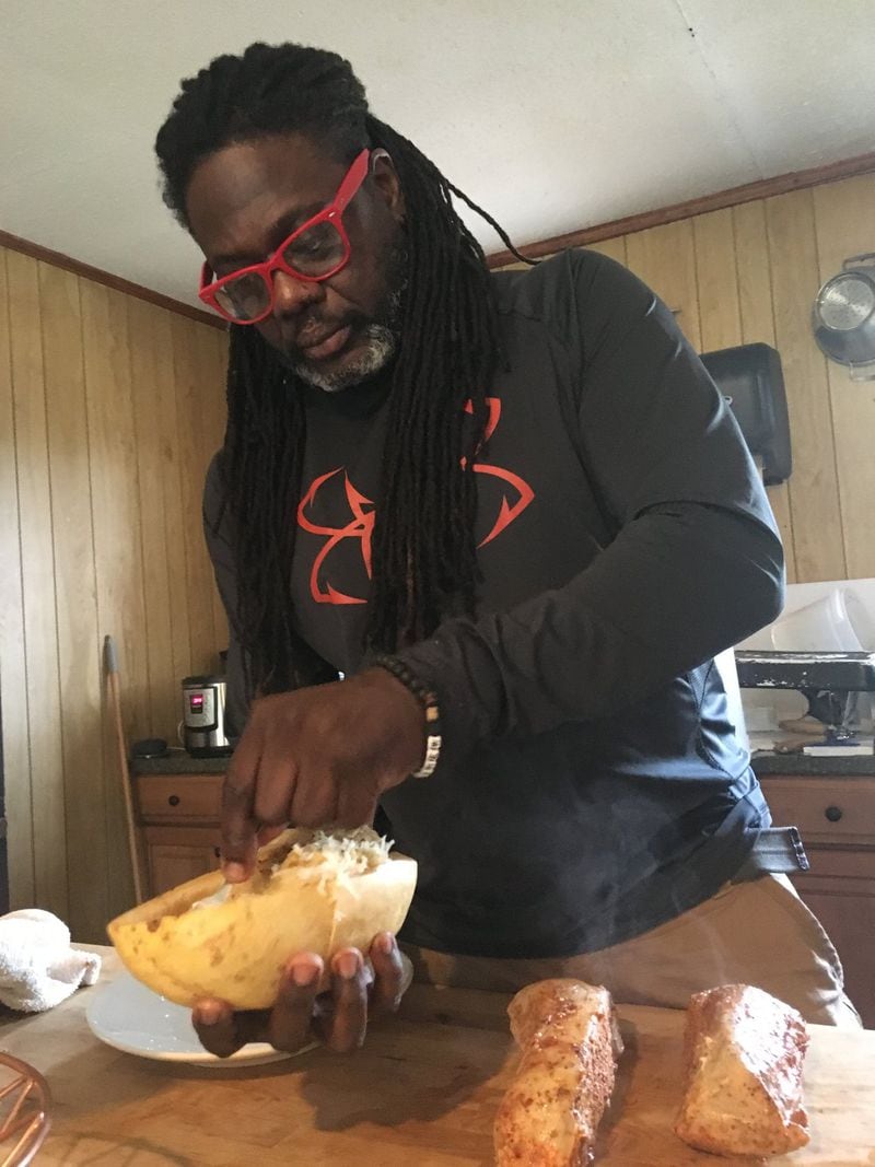 Chef Matthew Raiford scoops cooked spaghetti squash from its shell in preparation for serving at Gilliard Farms. CONTRIBUTED BY NINA MUKERJEE FURSTENAU