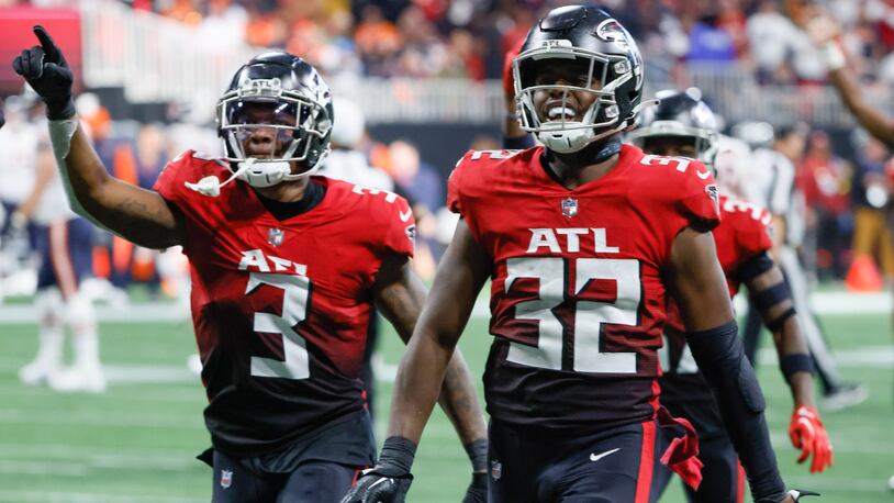 Atlanta Falcons safety Jaylinn Hawkins (32) celebrates with Mykal Walker (3) after he intercepted a Chicago Bears' Justin Fields' pass to close the game during the fourth quarter of an NFL football game between the Atlanta Falcons and the Chicago Bears In Atlanta on Sunday, Nov. 20, 2022. The Falcons won 27 -24.  (Bob Andres for the Atlanta Journal Constitution)