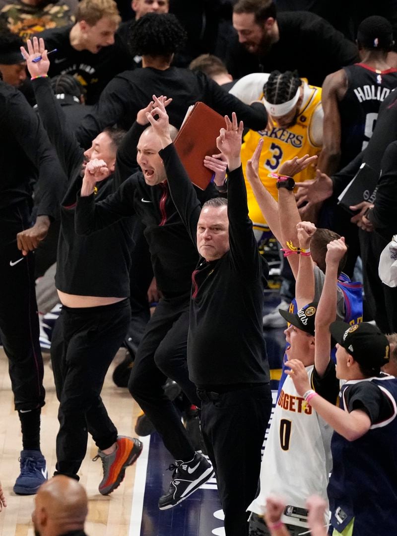 Denver Nuggets head coach Michael Malone, center, celebrates the game-winning basket at the buzzer by Jamal Murray against the Los Angeles Lakers in Game 2 of an NBA basketball first-round playoff series Monday, April 22, 2024, in Denver. (AP Photo/Jack Dempsey)