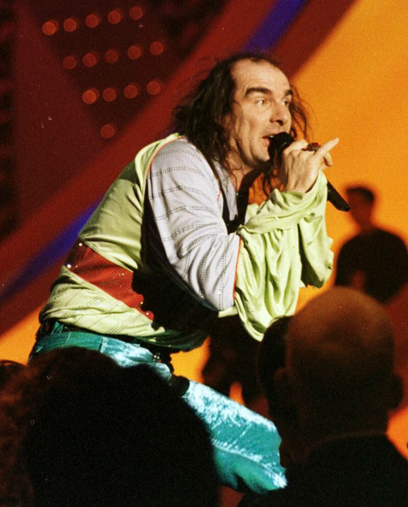 FILE - Germany's Guildo Horn performs on stage in the final dress rehearsal in Birmingham, England, Saturday, May 9, 1998, ahead of the final. The 68th Eurovision Song Contest is taking place in May in Malmö, Sweden. It will see acts from 37 countries vie for the continent’s pop crown. Founded in 1956, Eurovision is a feelgood extravaganza that strives to banish international strife and division. It’s known for songs that range from anthemic to extremely silly, often with elaborate costumes and spectacular staging. (AP Photo/Louisa Buller, File)