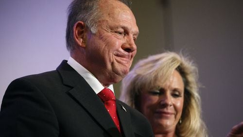 U.S. Senate candidate Roy Moore, a former chief justice of Alabama’s Supreme Court, speaks at a news conference Thursday in Birmingham, Ala., with his wife, Kayla Moore, at his side. (AP Photo/Brynn Anderson)