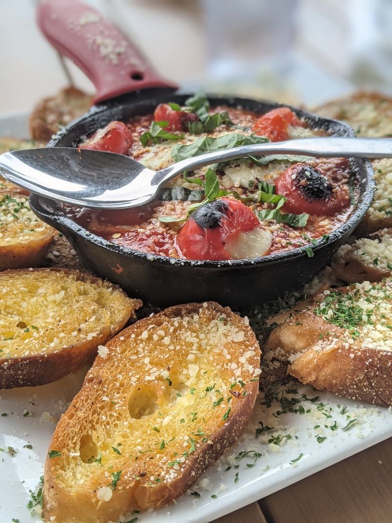 Diavolo Peppers, featuring red peppers stuffed with honeyed goat cheese and served in a spicy fra diavolo sauce with crostini, are a popular starter at Five Boroughs Pizza Tavern. (Courtesy of Paula Pontes)