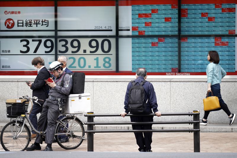 A person looks at an electronic stock board showing Japan's Nikkei 225 index at a securities firm Thursday, April 25, 2024, in Tokyo. (AP Photo/Eugene Hoshiko)