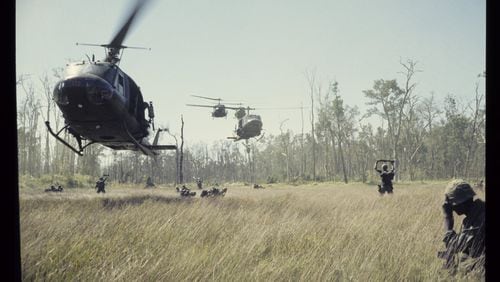 Huey helicopters swarm toward a landing zone in a photo by Tucker resident 1st Lt. James H. Holcombe Jr. The photo is part of “More Than Self: Living the Vietnam War,” a new exhibit at the Atlanta History Center. CONTRIBUTED BY JAMES H. HOLCOMBE JR.