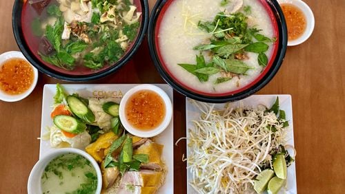 This meal at Duluth’s Com Ga Houston includes bun mang, duck congee, fresh herbs and bean sprouts for garnishing the bowls, and com ga (chicken with rice). Wendell Brock for The Atlanta Journal-Constitution