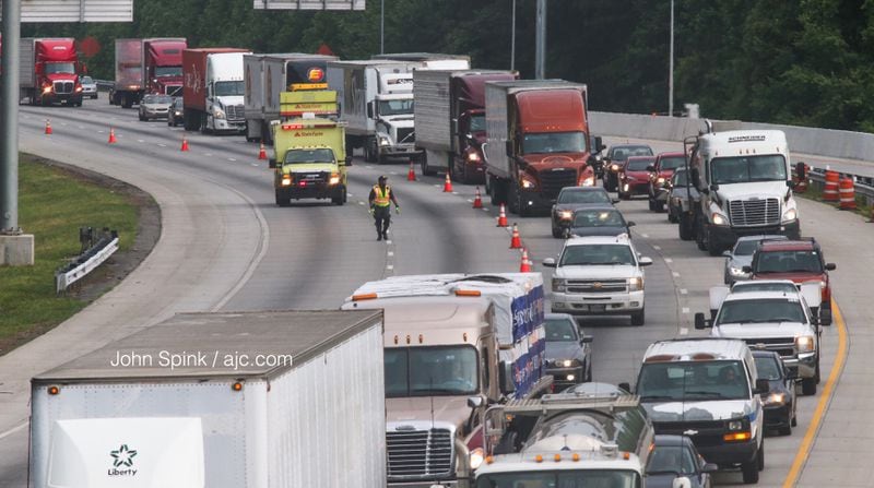 Traffic on I-75 South at Ga. 92 is moving again after a tractor-trailer hauling 19 cows overturned Thursday morning. Traffic was delayed for several hours beginning at 5 a.m. JOHN SPINK / JSPINK@AJC.COM
