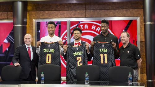 Atlanta Hawks General Manager, Travis Schlenk (far left), and Head Coach Mike Budenholzer (far right), stand on the outside of rookies: John Collins (left), Tyler Dorsey (middle) and Alpha Kaba (right).  Chad Rhym/ Chad.Rhym@ajc.com