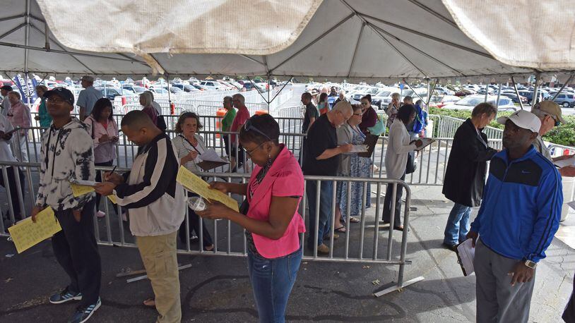 People lined up for early voting in Gwinnett County. Georgia purged more than 600,000 people from voter rolls in 2017. HYOSUB SHIN / HSHIN@AJC.COM