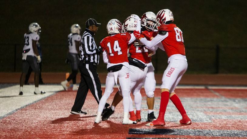 Members of the Milton football team celebrate a touchdown during the Milton vs. Norcross high school football game on Friday, November 18, 2022, at Milton high school in Milton, Georgia. Milton defeated Norcross 30-23.