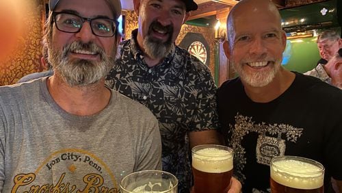 Brick Store Pub co-owners (from left) Tom Moore, Mike Gallagher and Dave Blanchard enjoy a hand-pulled pint at the Cask Bar. Bob Townsend for The Atlanta Journal-Constitution