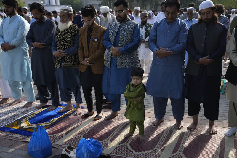 Muslims perform an Eid al-Fitr prayer, marking the end of the fasting month of Ramadan, in Rawalpindi, Pakistan, Wednesday, April, 10, 2024. (AP Photo/Anjum Naveed)
