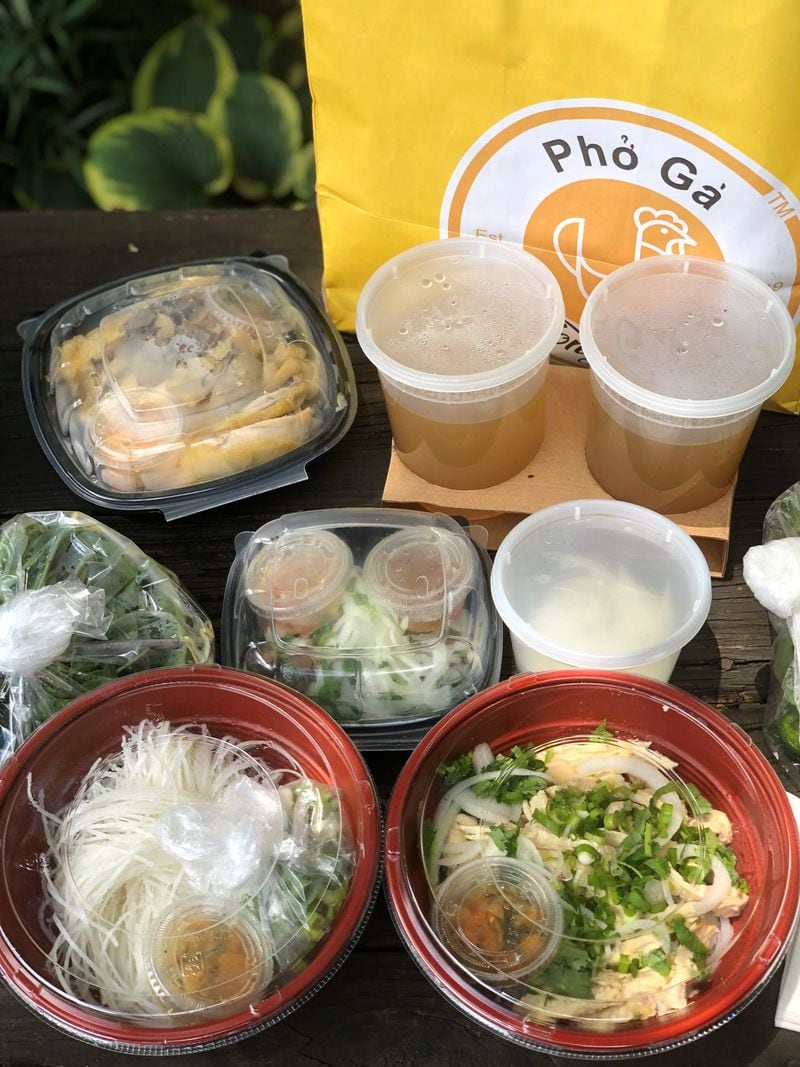This takeout order from Pho Ga Tony Tony includes half of a chicken with pho, broth, garnishes and condiments; an order of pho with shredded white meat in the bowl; an order of giblets; and pickled onions. CONTRIBUTED BY WENDELL BROCK