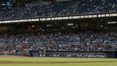 An emergency message warning flashes on a sign board during the game between the Braves and Pirates at SunTrust Park. A loud alarm signal and flashing lights startled fans Tuesday night, just a day after an attack by a suicide bomber at a pop concert in Manchester, England, left at least 22 dead. (AP Photo/John Bazemore)