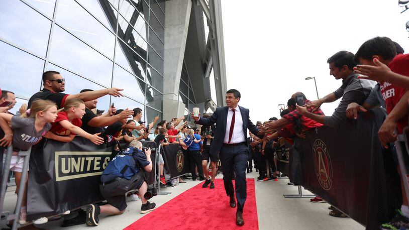 Atlanta United manager Gonzalo Pineda high-fives fans as the team arrived at Mercedes-Benz Stadium moments before Atlanta United and the New England Revolution soccer game on Sunday, May 15, 2022. Miguel Martinez / miguel.martinezjimenez@ajc.com