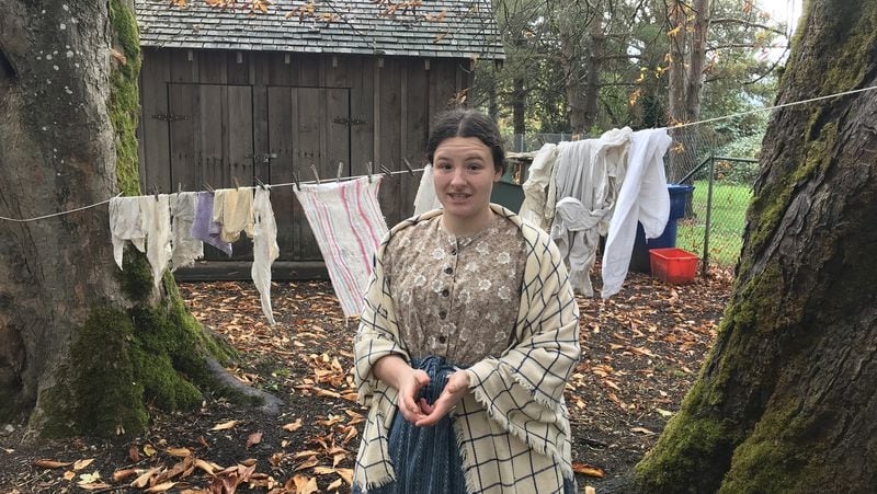 Cassie Whitlock, dressed in period garb, talks about 19th century life on the Oregon Trail. Whitlock is a tour leader at Philip Foster Farm in Eagle Creek, Ore. The farm was an important rest stop for travelers on the trail. (Lori Rackl/Chicago Tribune/TNS)