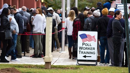 People wait in a long line to vote at the Cobb County Board of Elections and Registration office in Marietta on Oct. 27, 2018. STEVE SCHAEFER / SPECIAL TO THE AJC