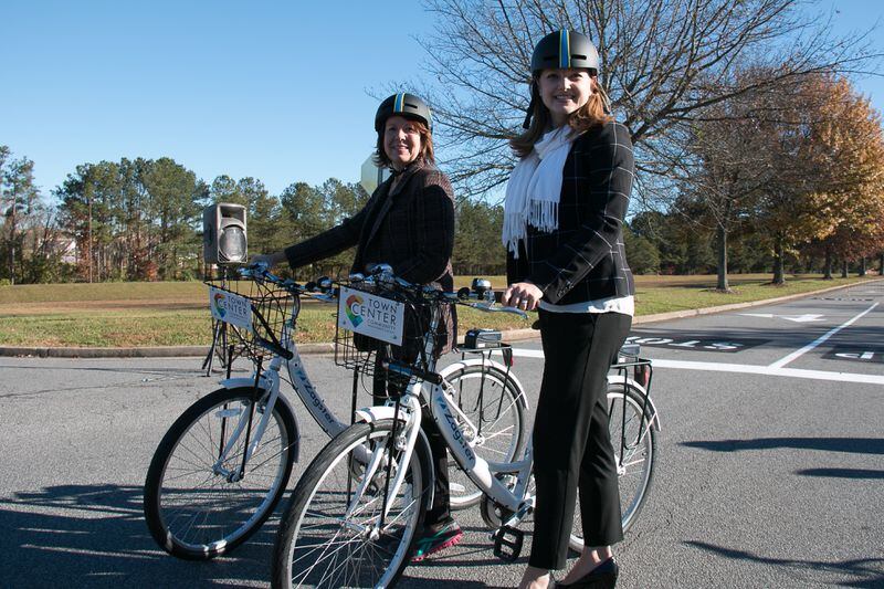 Faye DiMassimo, (left) the director of the Cobb County Department of Transportation, and Tracy Rathbone, (right) executive director of Town Center Community Improvement District pose with new Zagster bike share bicycles on Friday, Nov. 20, 2015. Photo courtesy of Town Center CID.