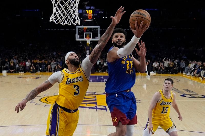 Denver Nuggets guard Jamal Murray (27) shoots against tLos Angeles Lakers forward Anthony Davis (3) during the second half of Game 3 of an NBA basketball first-round playoff series in Los Angeles, Thursday, April 25, 2024. (AP Photo/Ashley Landis)