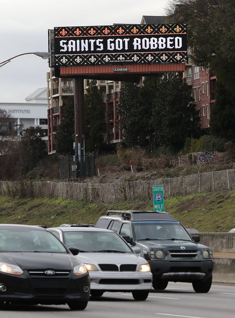 A digital billboard seen Tuesday on I-85 South at Peachtree Road in Atlanta reads “Saints Got Robbed” in reaction to the non-call on a pass interferance play by the Rams against the Saints in the NFC Championship Game. Curtis Compton/ccompton@ajc.com