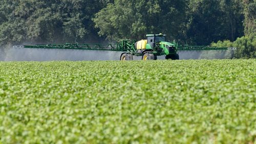 A Georgia farmer operates a John Deere sprayer to control weeds on a cotton field in Doerun, GA. The average age of Georgia farmers continues to increase even as the overall number of farmer laborers and agriculture producers in the state continues to shrink, according to the latest U.S. Census of Agriculture. (Hyosub Shin / Hyosub.Shin@ajc.com)